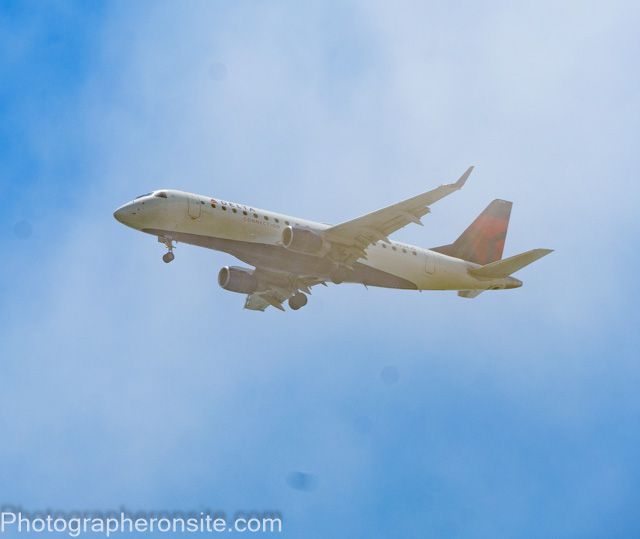 nice aviation image with an airplane framed by clouds.