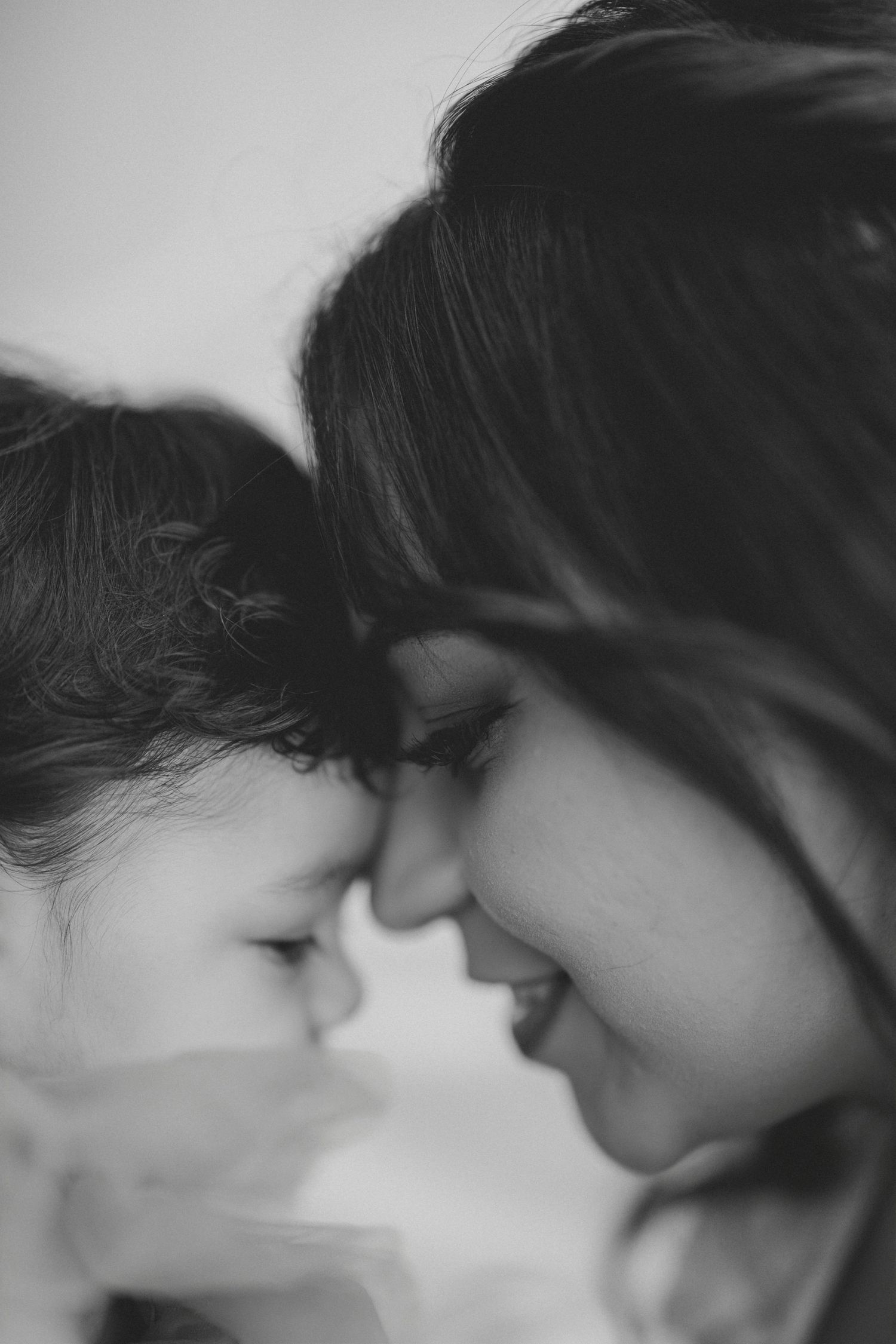Black and white close-up of mother and baby touching foreheads in tender intimate moment. Lafayette indiana tippecanoe county west lafayette