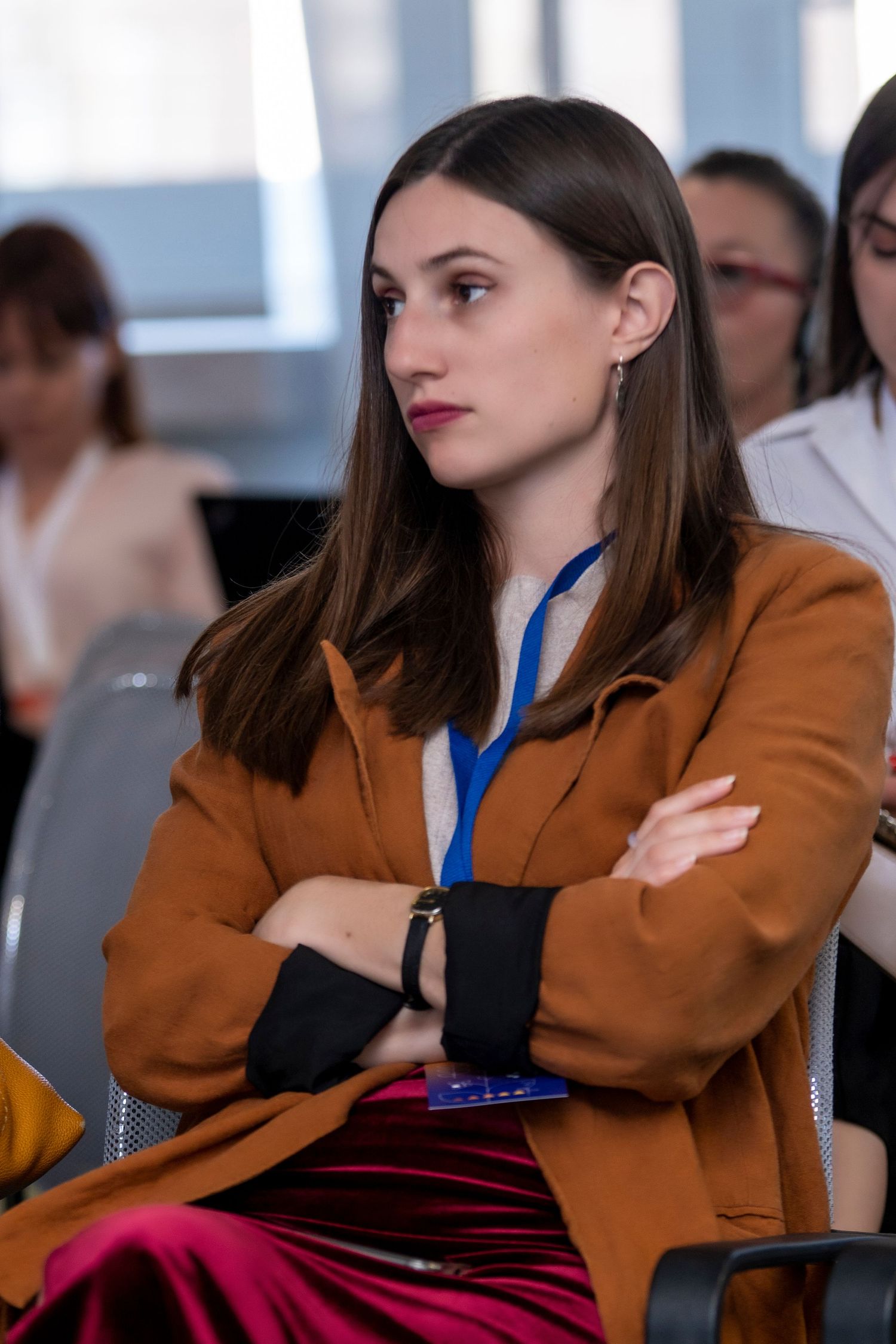 Corporate event photography featuring a professional woman attending a conference, captured by a wedding and portrait photographer