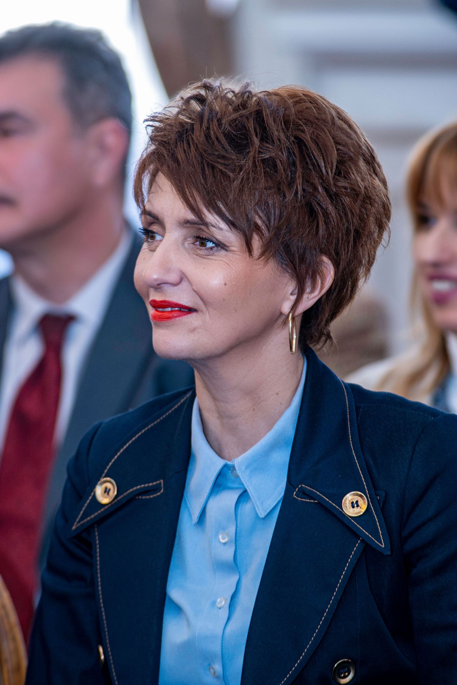 Corporate event photography featuring a professional woman attending a conference, captured by a wedding and portrait photographer