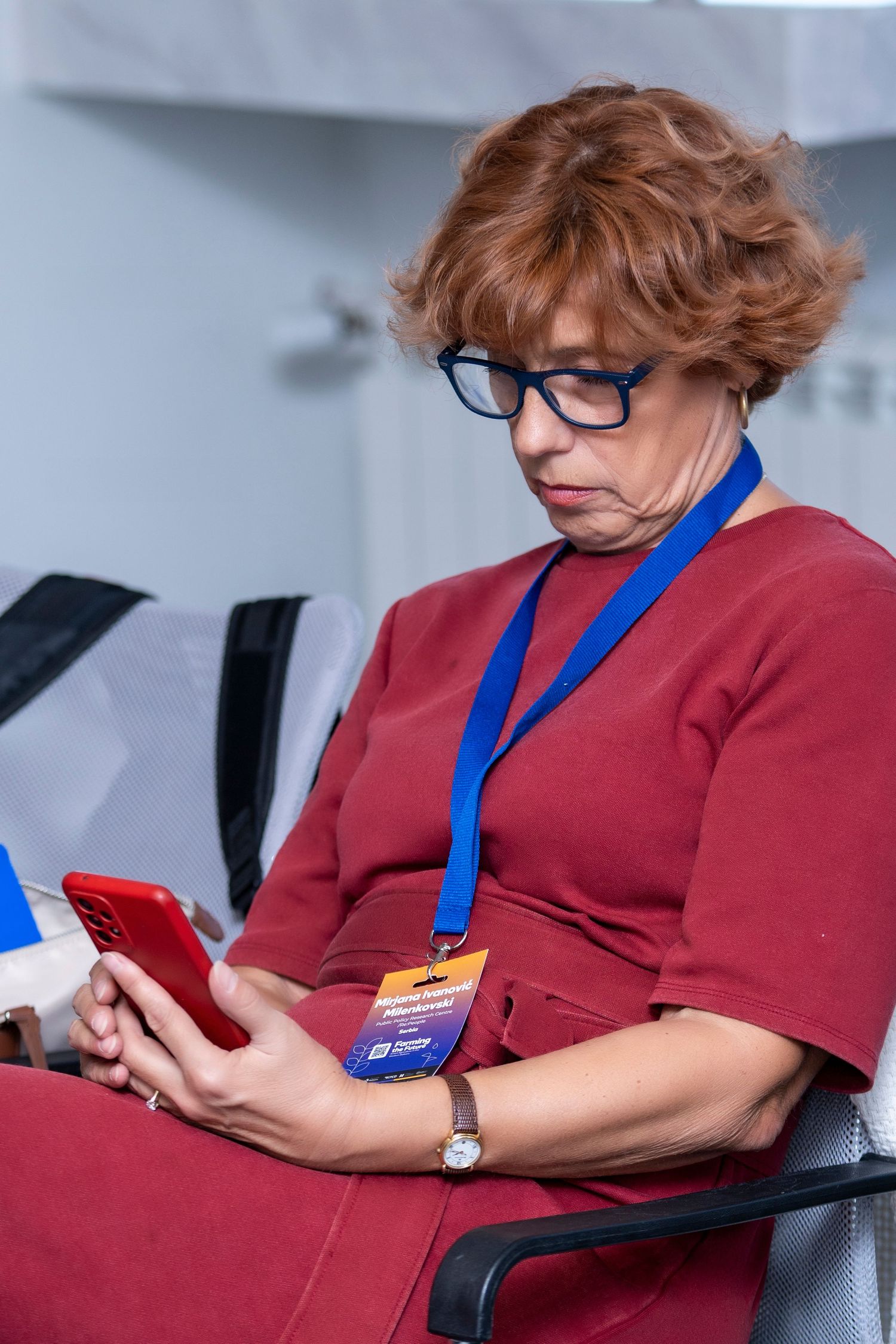 Corporate event photography featuring a professional woman attending a conference, captured by a wedding and portrait photographer