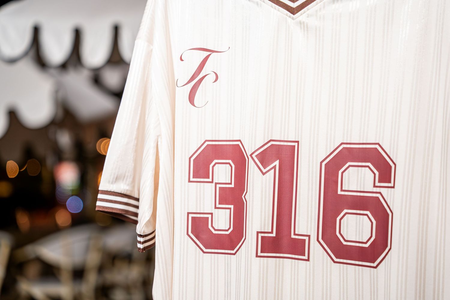 Cream pinstripe baseball jersey with TC logo and number 316 on front.