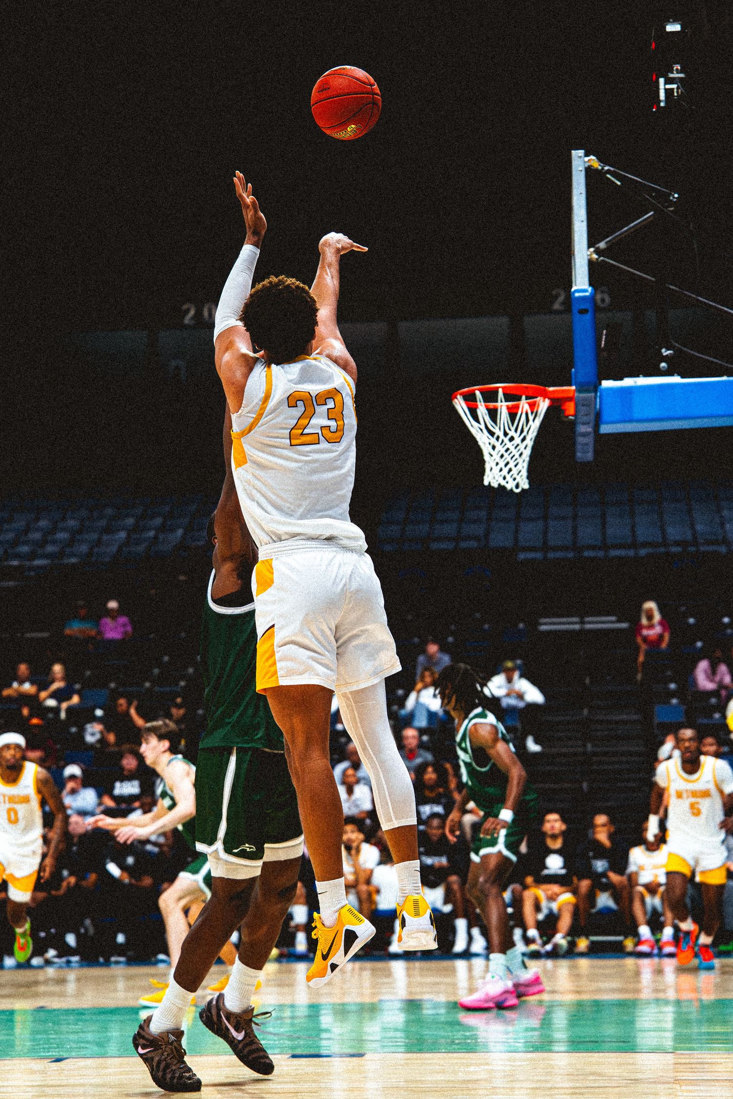 Bethune-Cookman player #23 shoots over a Jacksonville University defender during a college game.