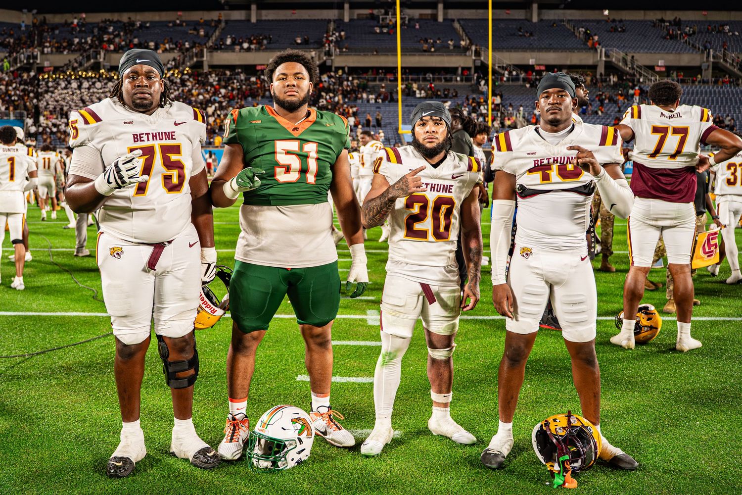 Bethune-Cookman football players pose together on field after Florida Classic game.