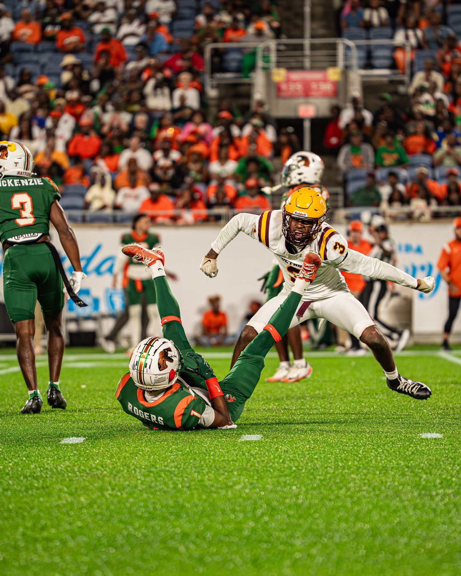 Bethune-Cookman defender leaps to make a play against a FAMU ball carrier on the field.