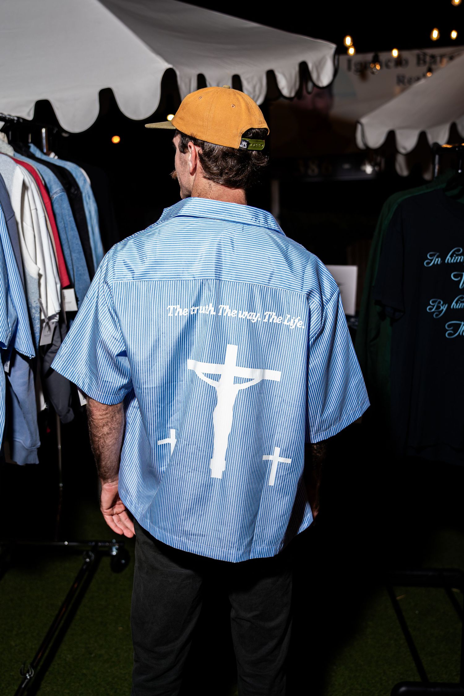 Man wearing blue button-up shirt with crucifixion graphic and The Truth The Way The Life text.
