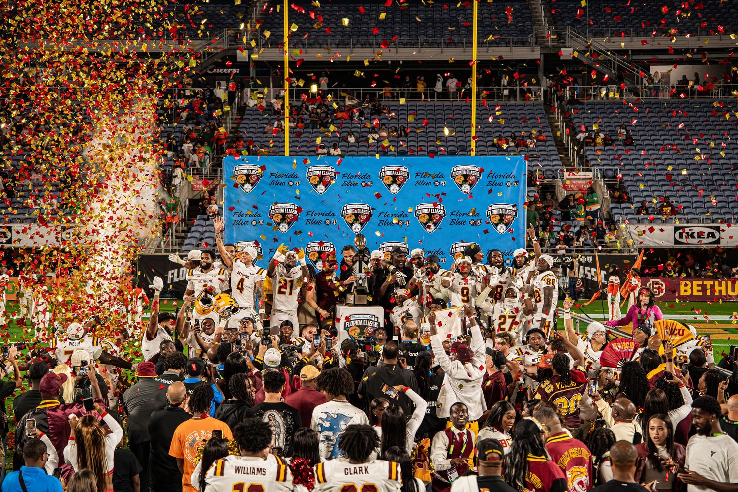 Bethune-Cookman football team celebrates Florida Classic victory with confetti on stage.