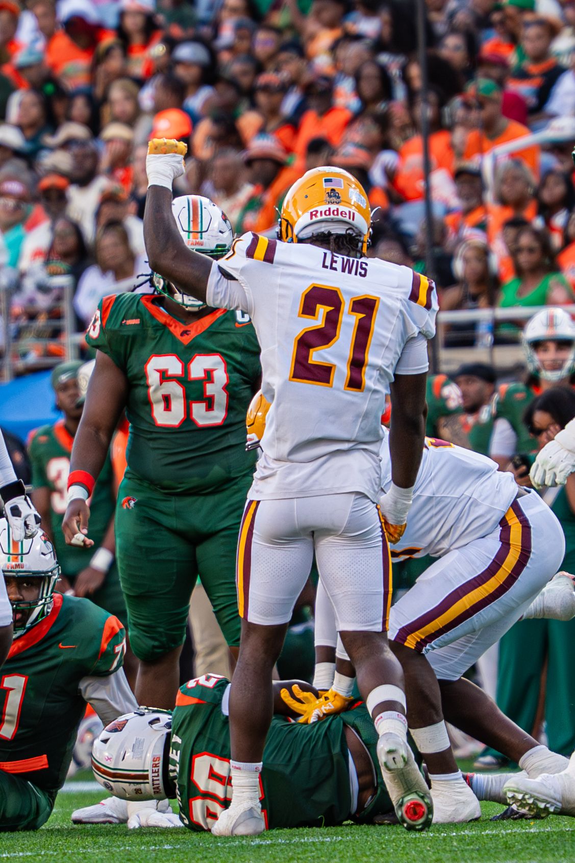 Bethune-Cookman player Lewis number 21 celebrates tackle during Florida Classic football game.