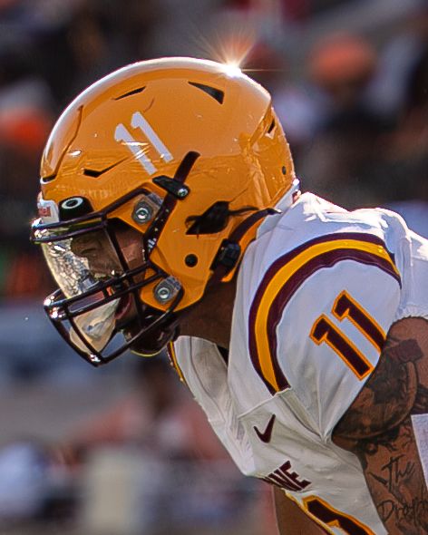 Bethune-Cookman player number 11 in orange helmet during college football game.