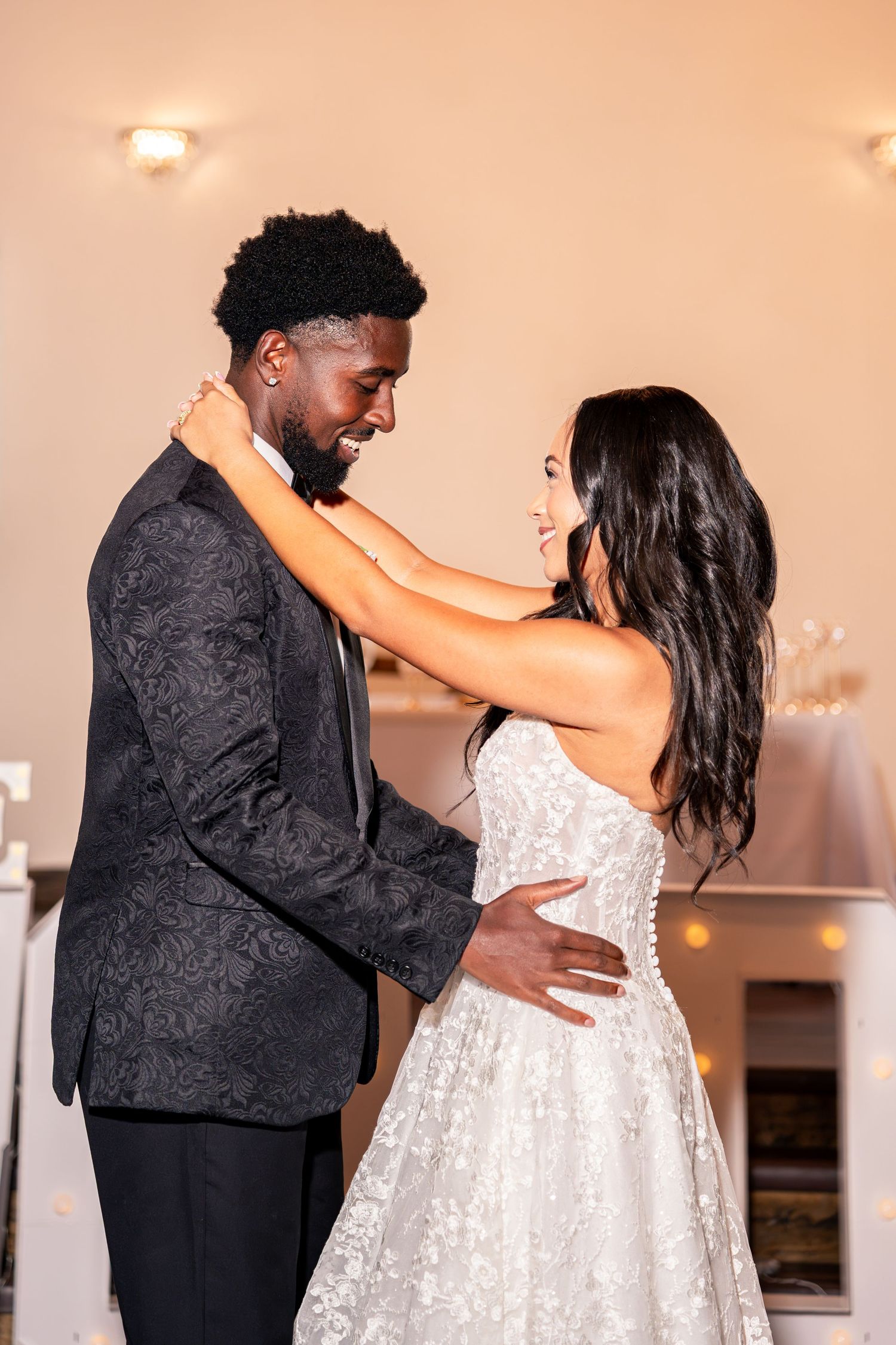 Bride and groom share intimate first dance at elegant wedding reception.