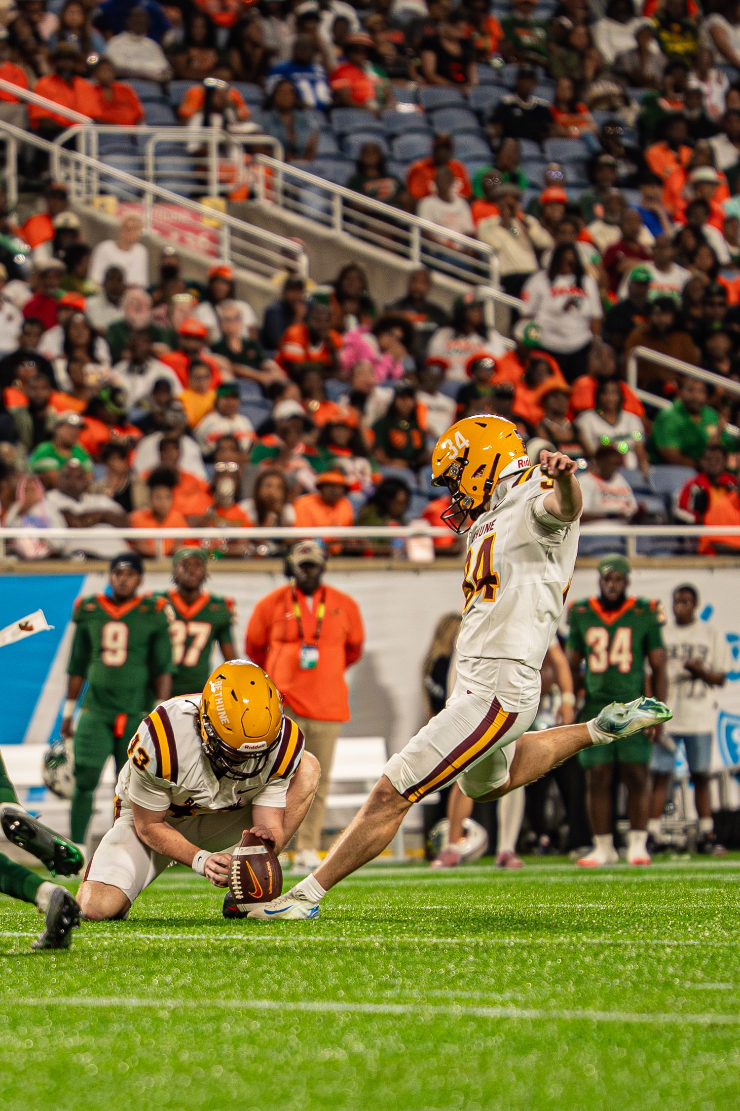 Bethune-Cookman kicker attempts a field goal during a college football game against FAMU.