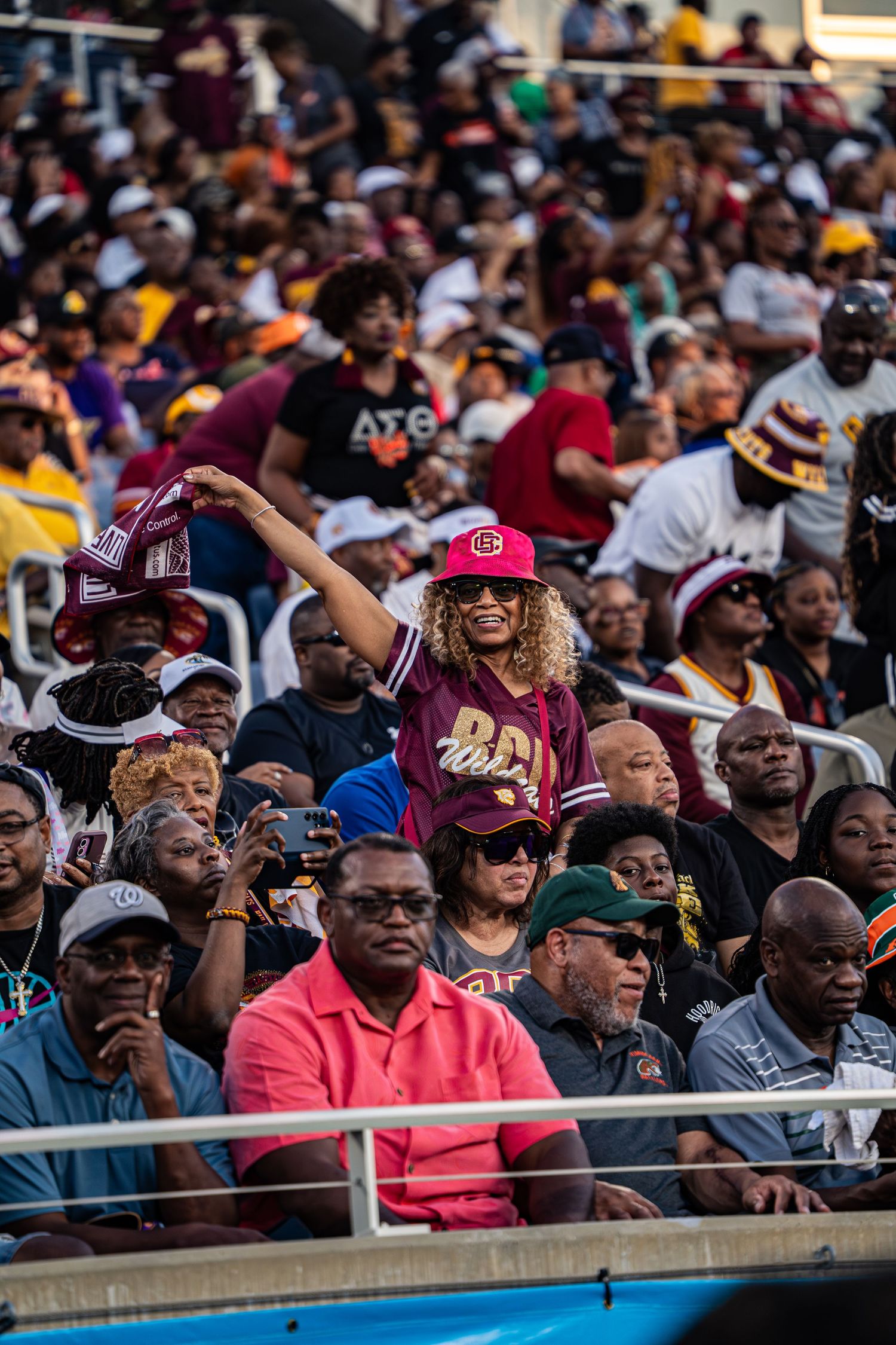 Enthusiastic Bethune-Cookman fan cheers in packed stadium during Florida Classic game.