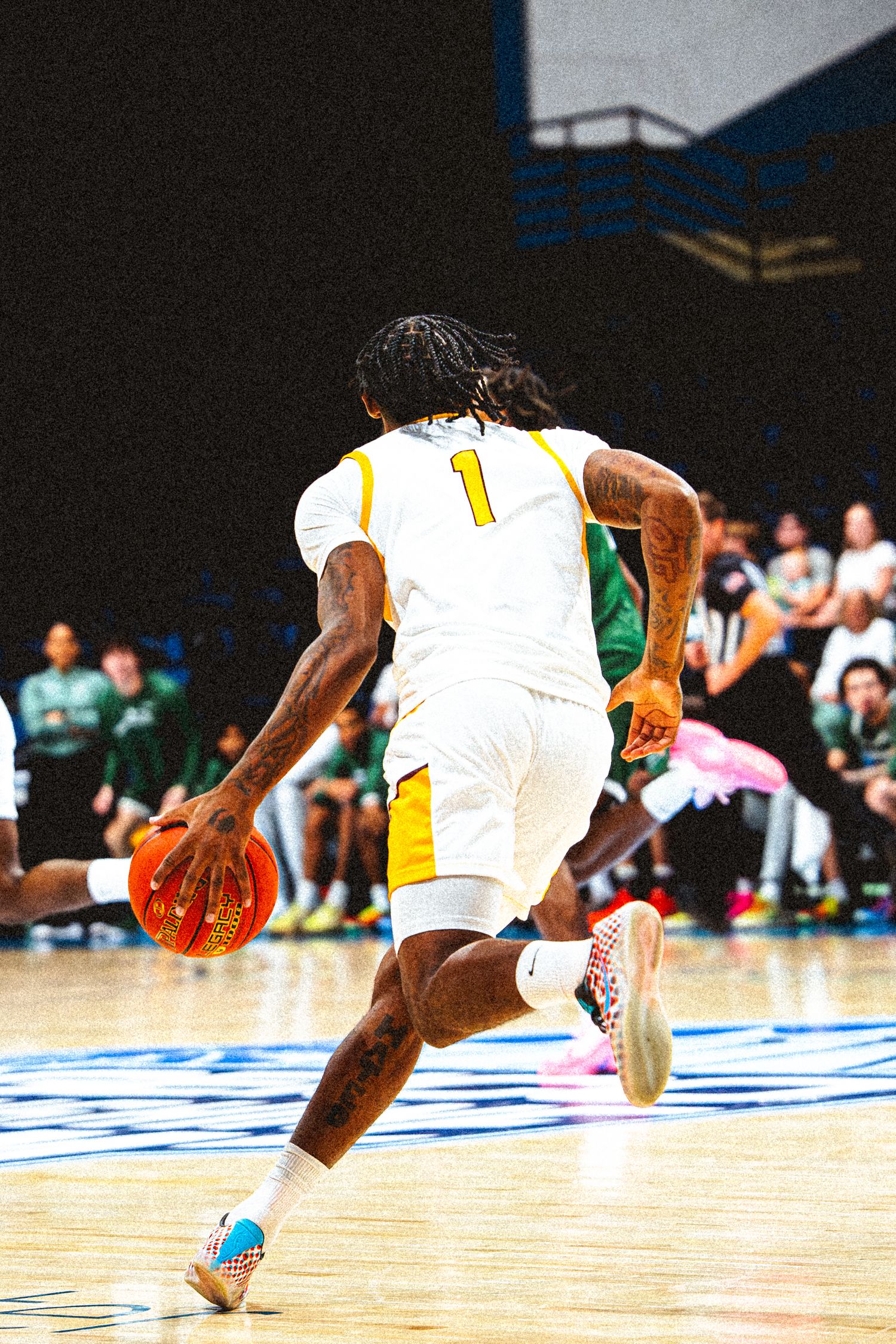Bethune-Cookman player #1 dribbles the ball upcourt during a college basketball game.