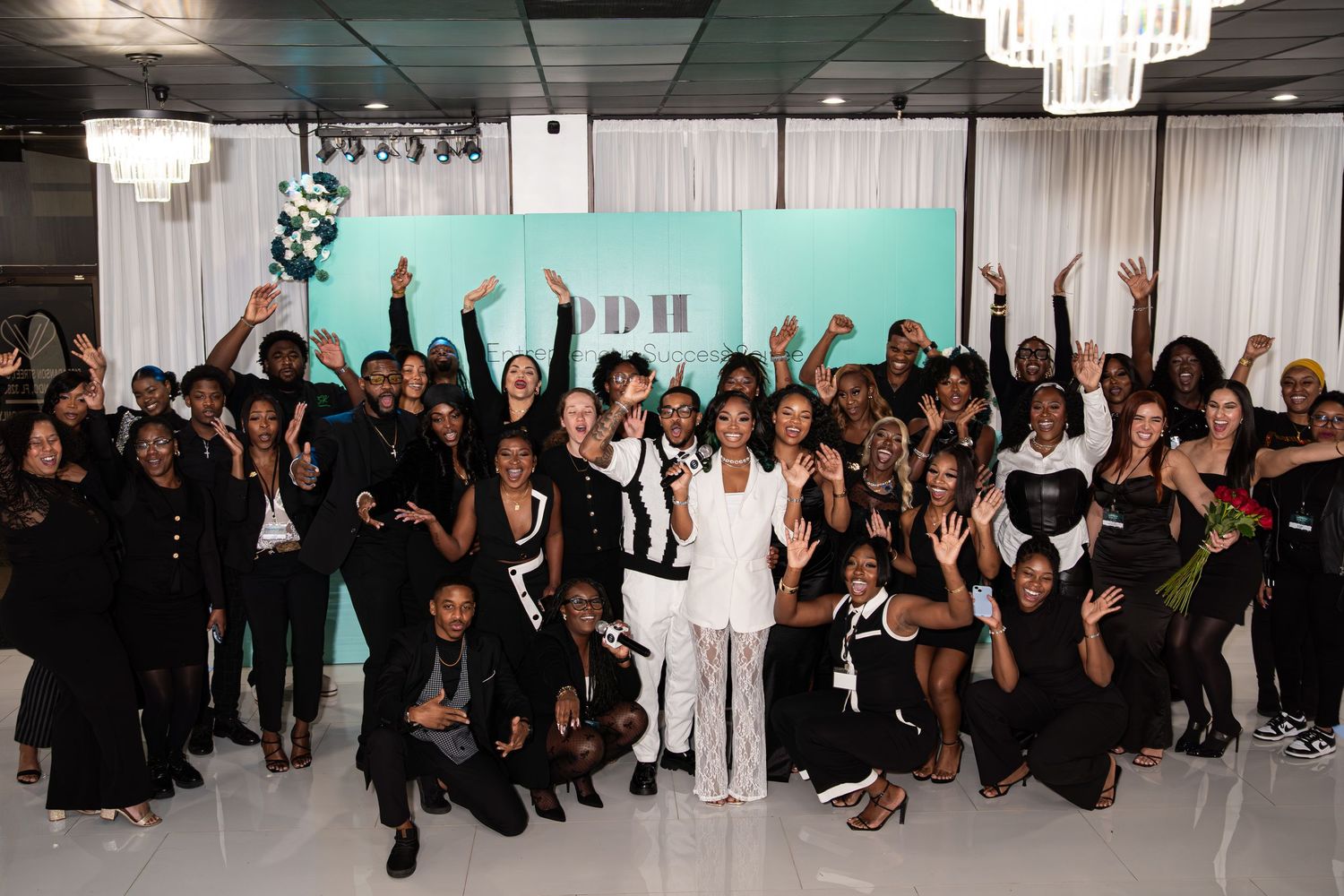 Large group of attendees celebrate together at DDH Entrepreneurial Success Summit event.