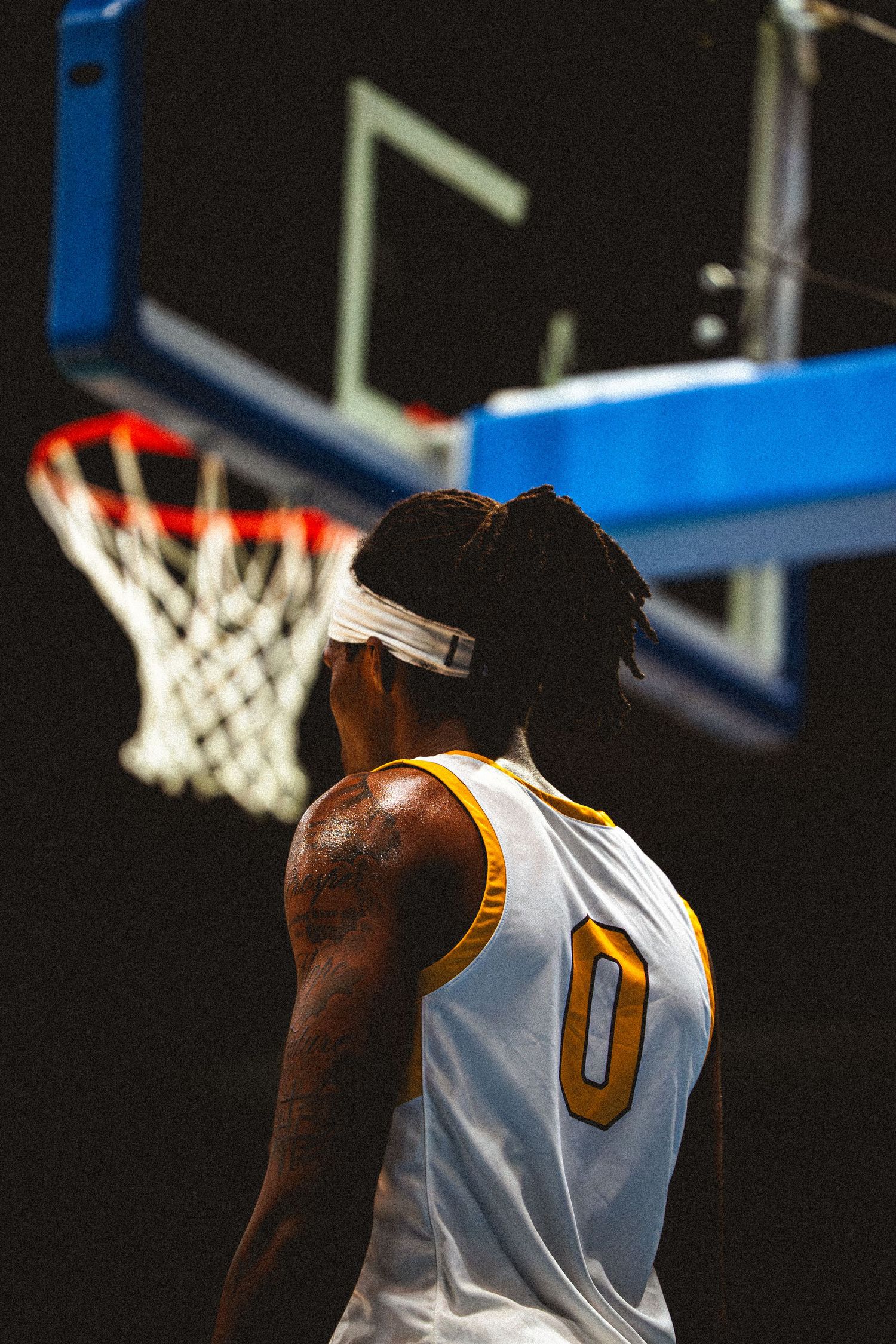 Bethune-Cookman basketball player #0 stands near the hoop during a game.