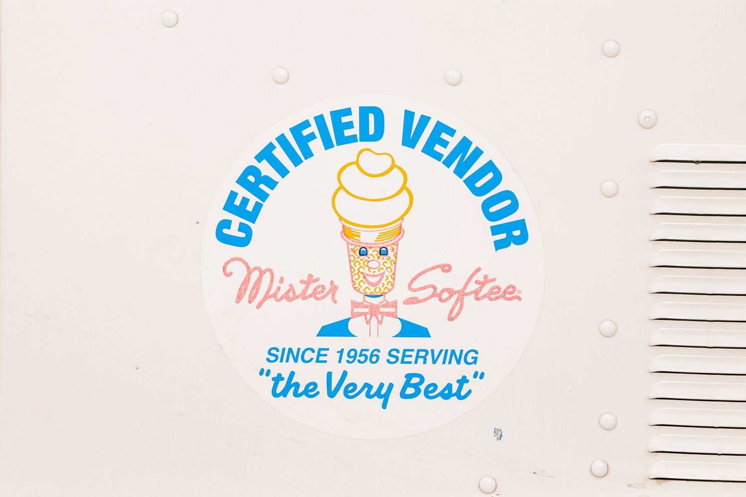 Mister Softee certified vendor logo sign on white ice cream truck since 1956.