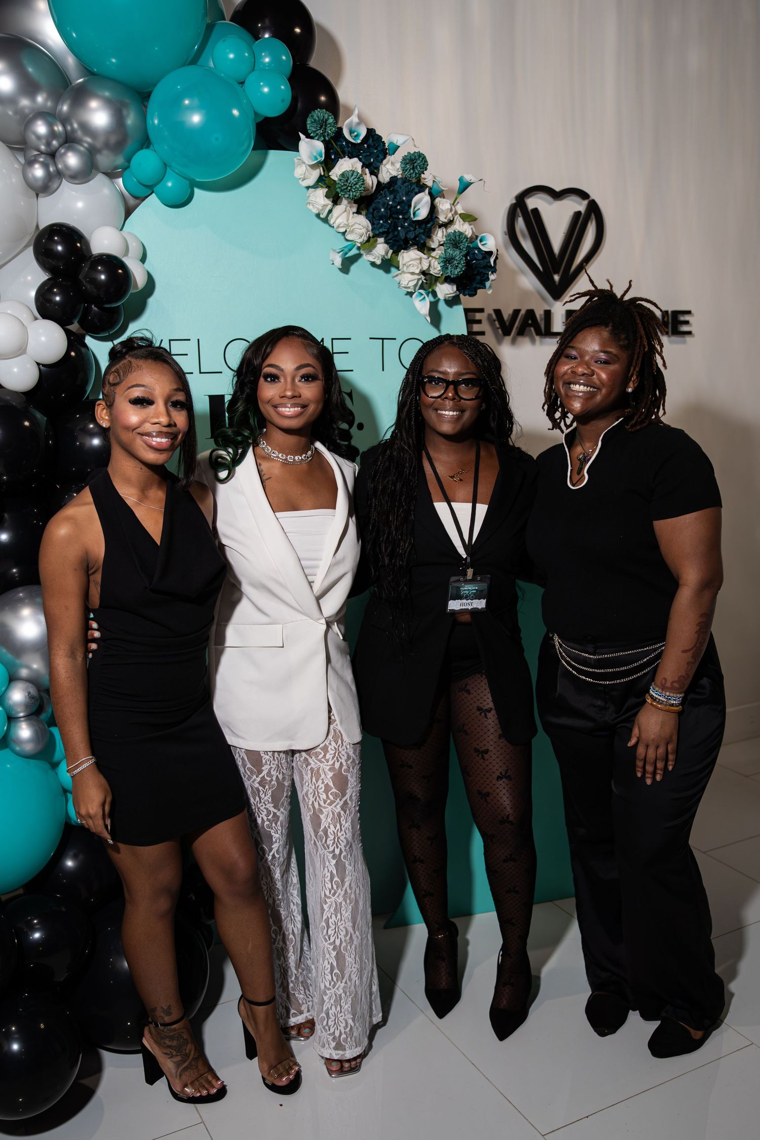 Four women pose together at ESS 2026 Valentine Vision Board Mixer event backdrop.