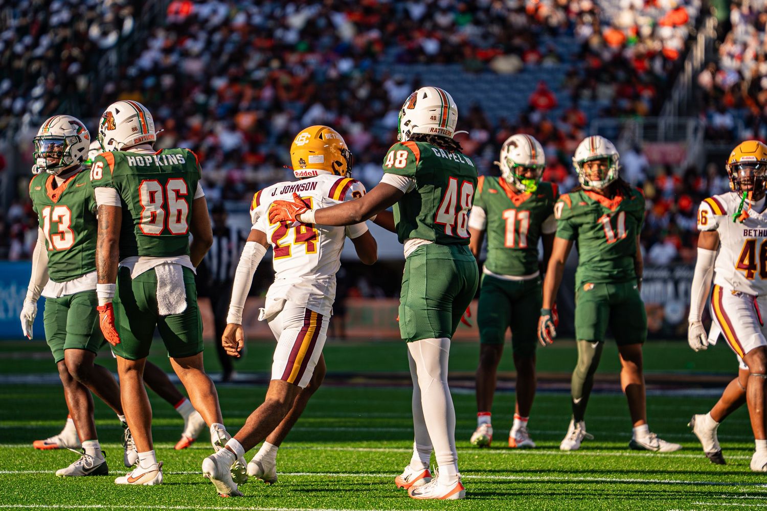 FAMU and Bethune-Cookman football players interact on field during Florida Classic game.