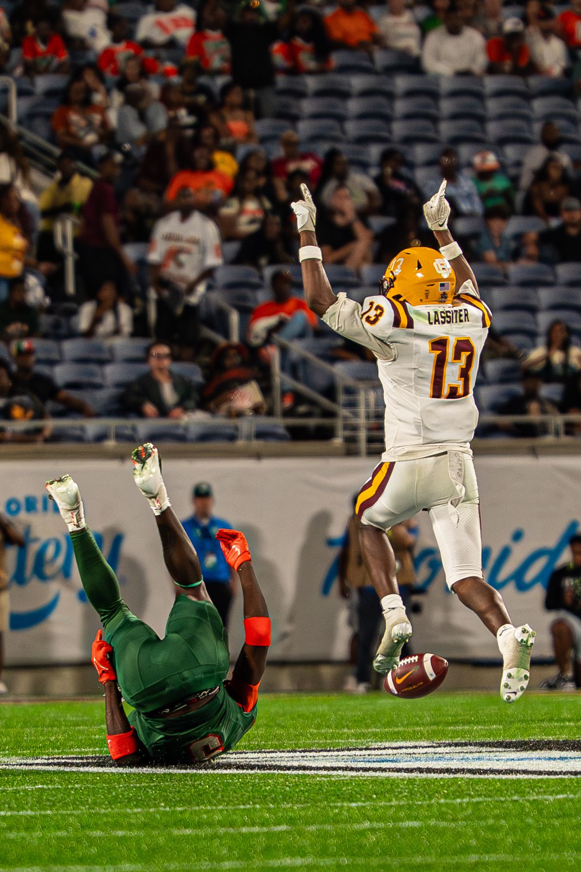 Bethune-Cookman player Lassiter #13 celebrates after a play against FAMU in college football.
