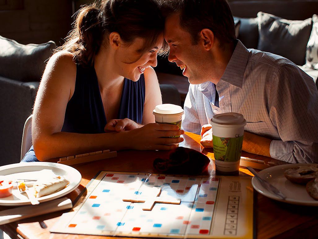 Engagement Portrait of a couple in a coffee shop playing Scrabble.