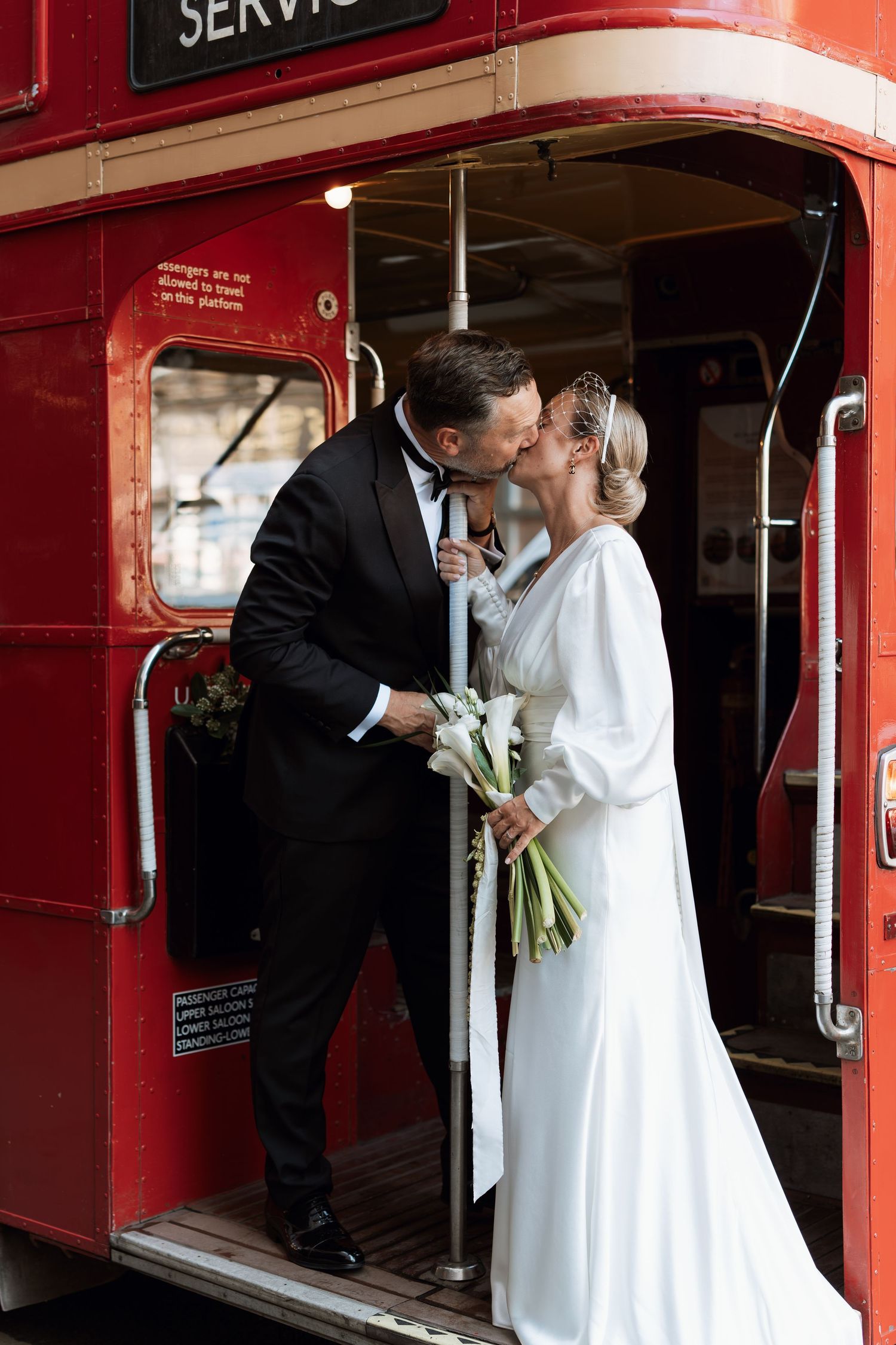 Wedding sequence of a couple entering a vintage red service train car.