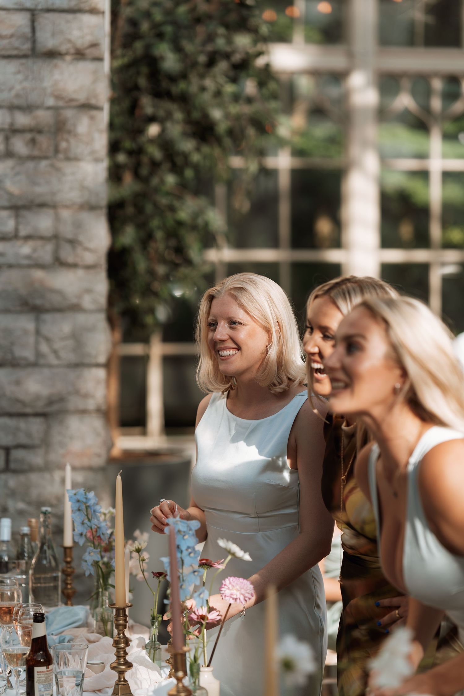 A multi-panel photo sequence shows women laughing and enjoying conversation at a formal dining table.