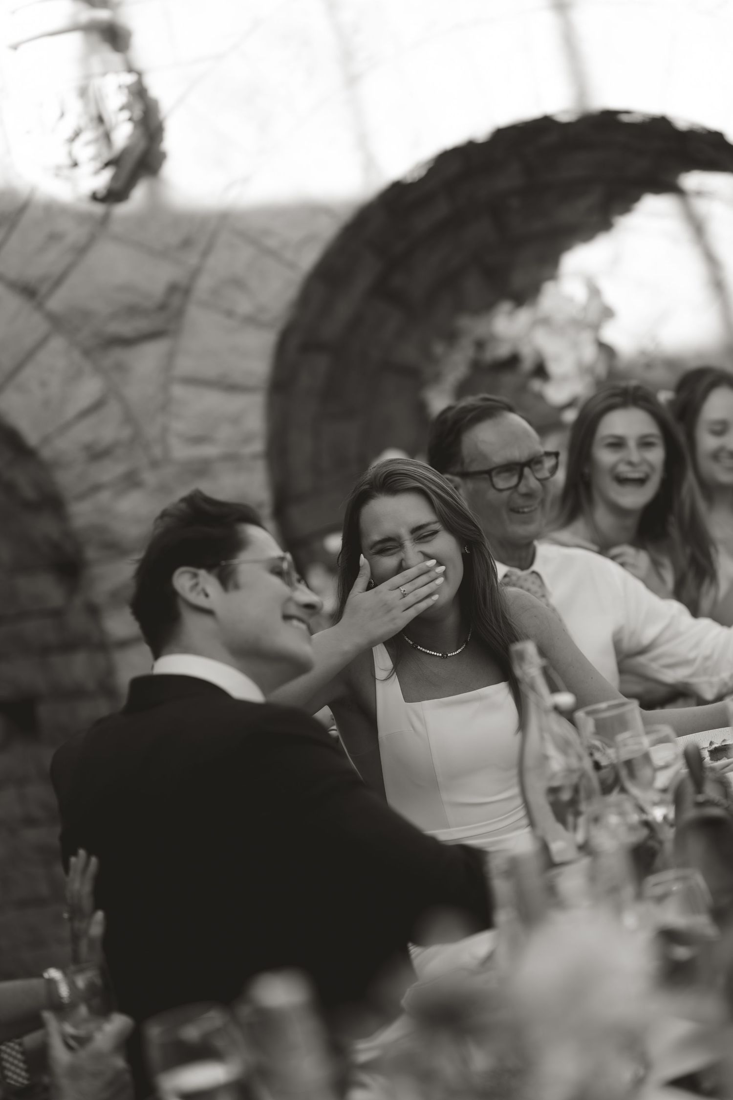 A black and white photo sequence shows a tender moment between people at what appears to be a wedding reception.
