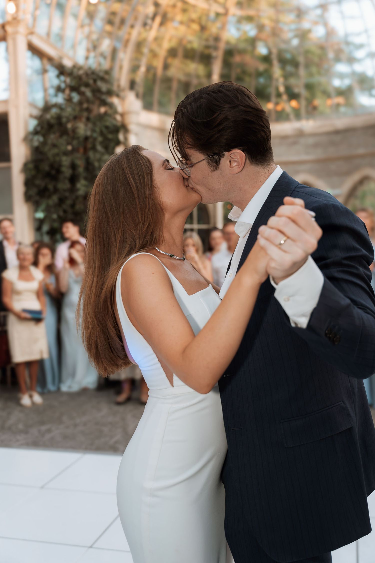 A romantic first dance moment at an elegant indoor wedding venue.