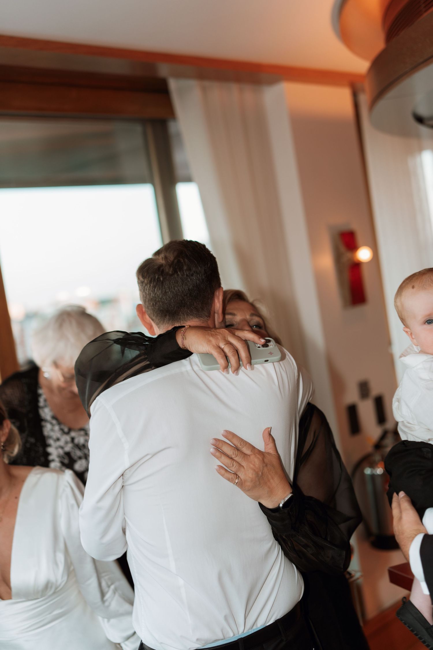 Two people sharing an emotional embrace at a wedding reception.