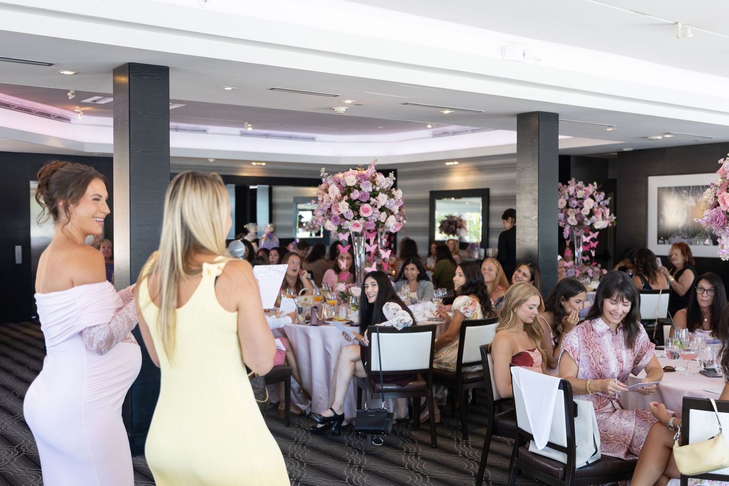 Mom-to-be and friend playing games at her baby shower at Harbor Club at Prime in Huntington New York. Capturing guest reactions.