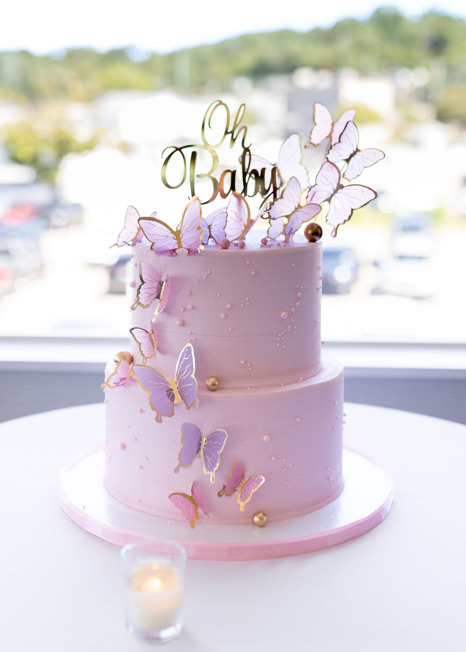 Pink two tier cake for a butterfly themed baby shower at Harbor Club at Prime in Huntington New York. Photo by Captured by Cristino