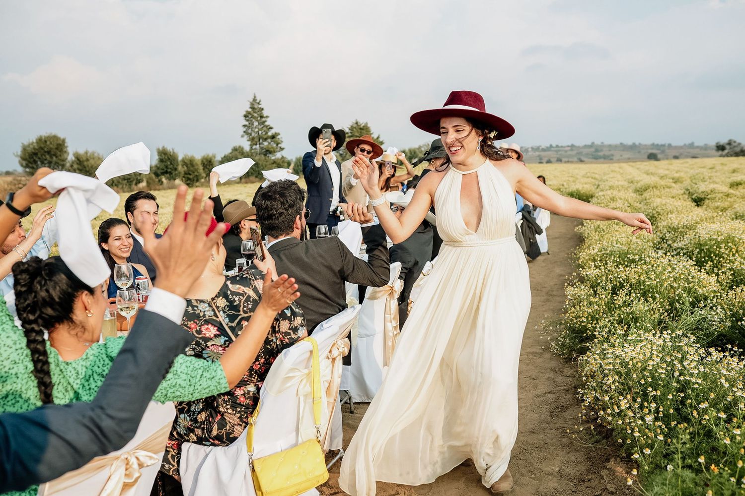 Bride smiling and dancing with guests