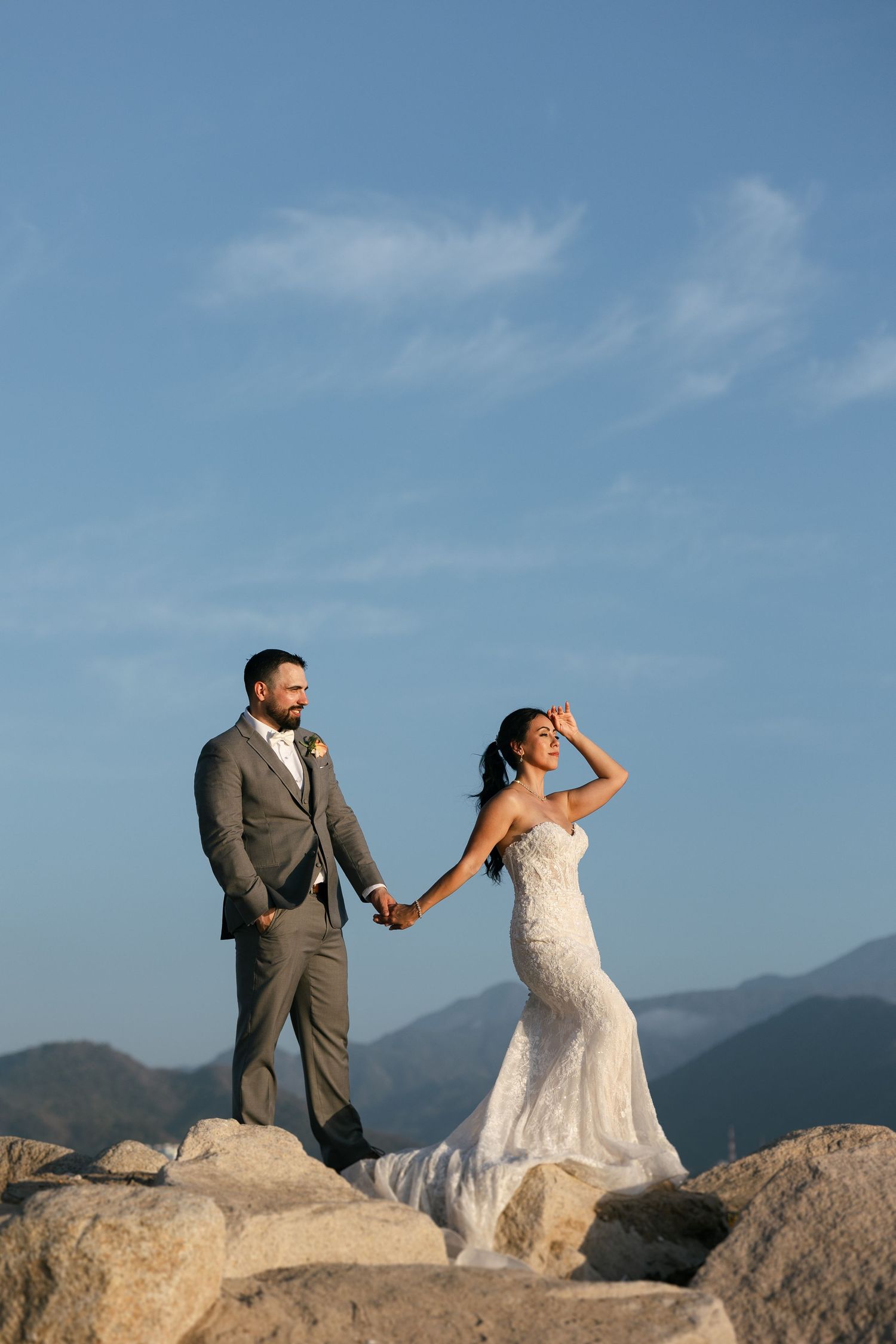 Bride and groom kissing at sunset on the beach in Punta Mita, Mexico