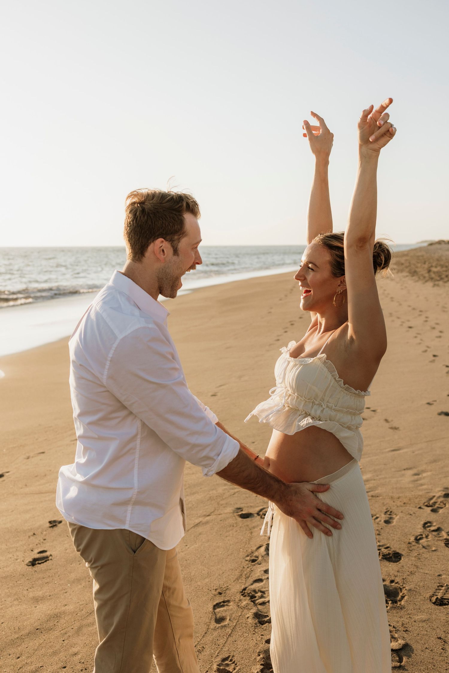 Parents-to-be sharing tender moment during Puerto Vallarta session