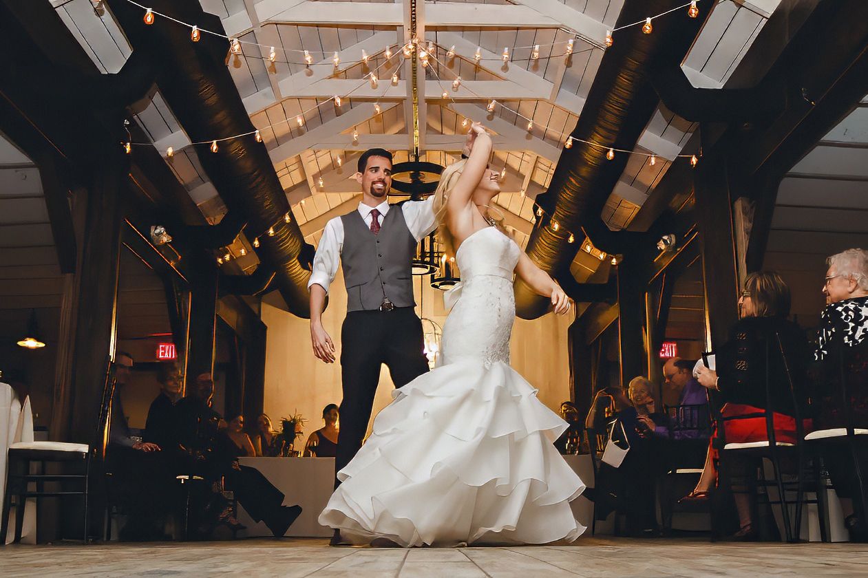 Bride and groom making a grand entrance onto the dance floor at their rustic barn wedding reception.