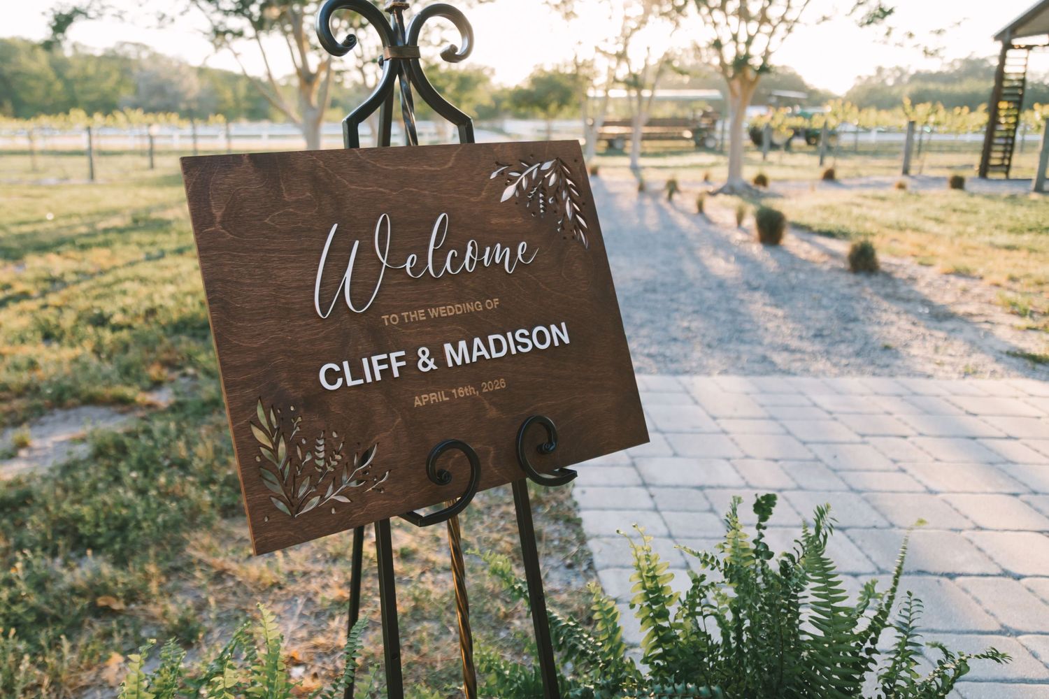 Rustic wooden welcome sign for Cliff and Madison wedding on an easel at Congaree and Penn venue.