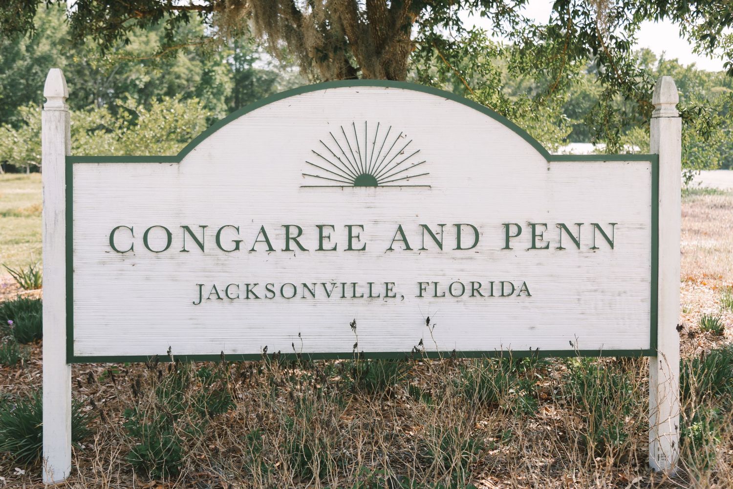 Congaree and Penn wedding venue sign in Jacksonville, Florida, surrounded by lush green trees.