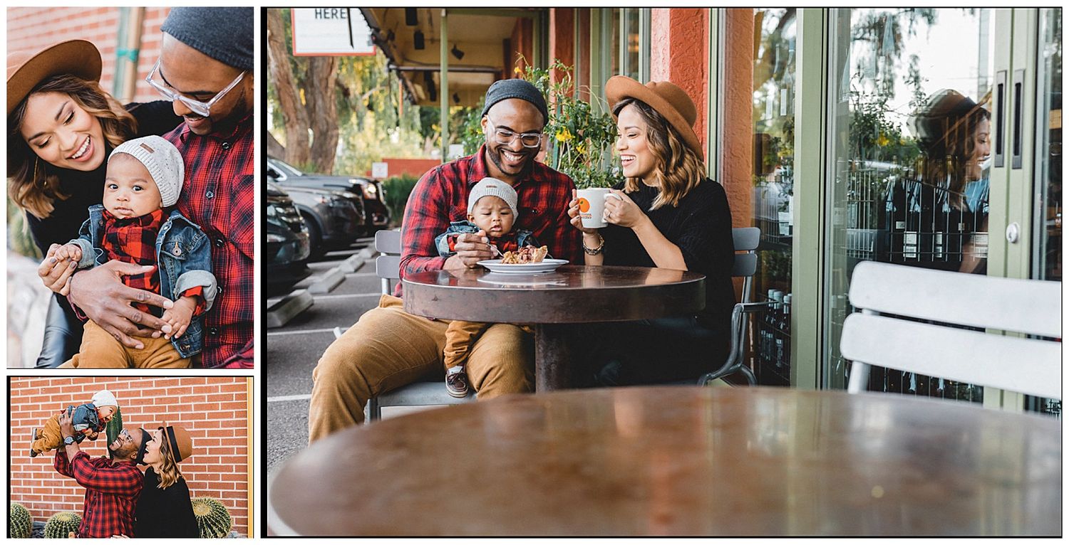 Happy multiracial family with baby enjoying coffee at outdoor cafe, parents smiling and bonding together.