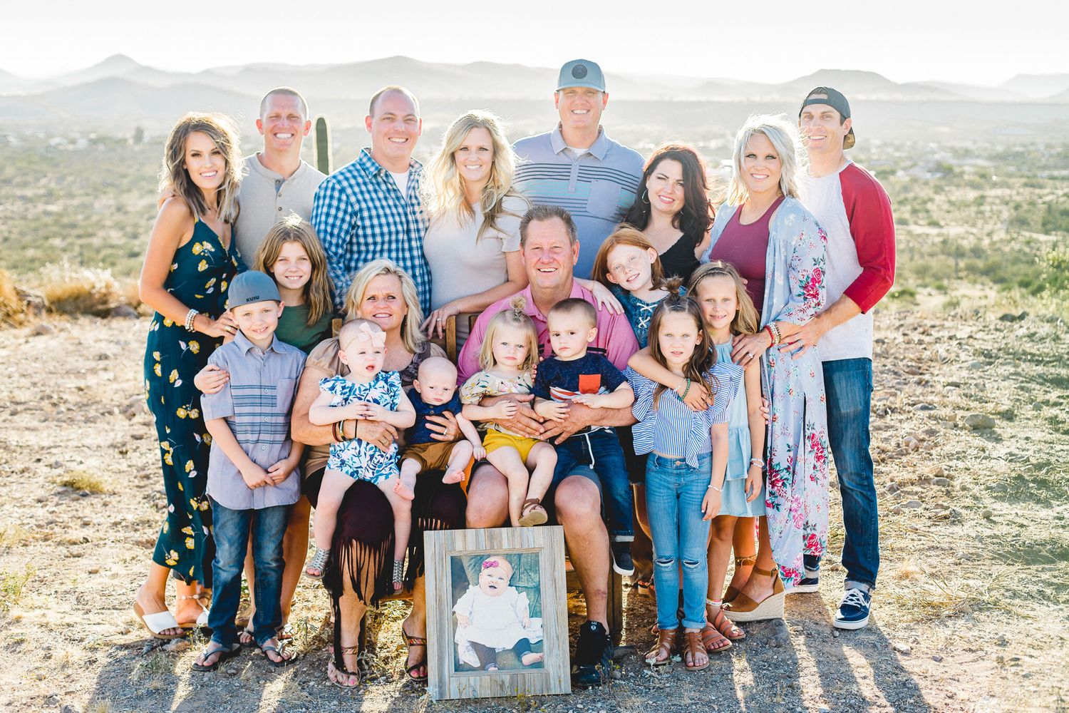 Large multigenerational family portrait in desert landscape.