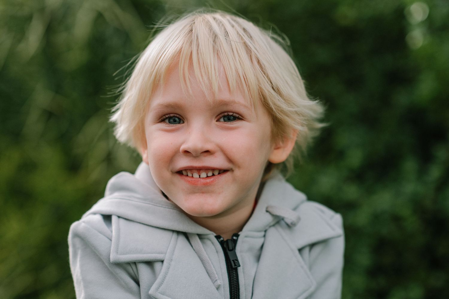 Light-hearted expressions captured in a series against green foliage.