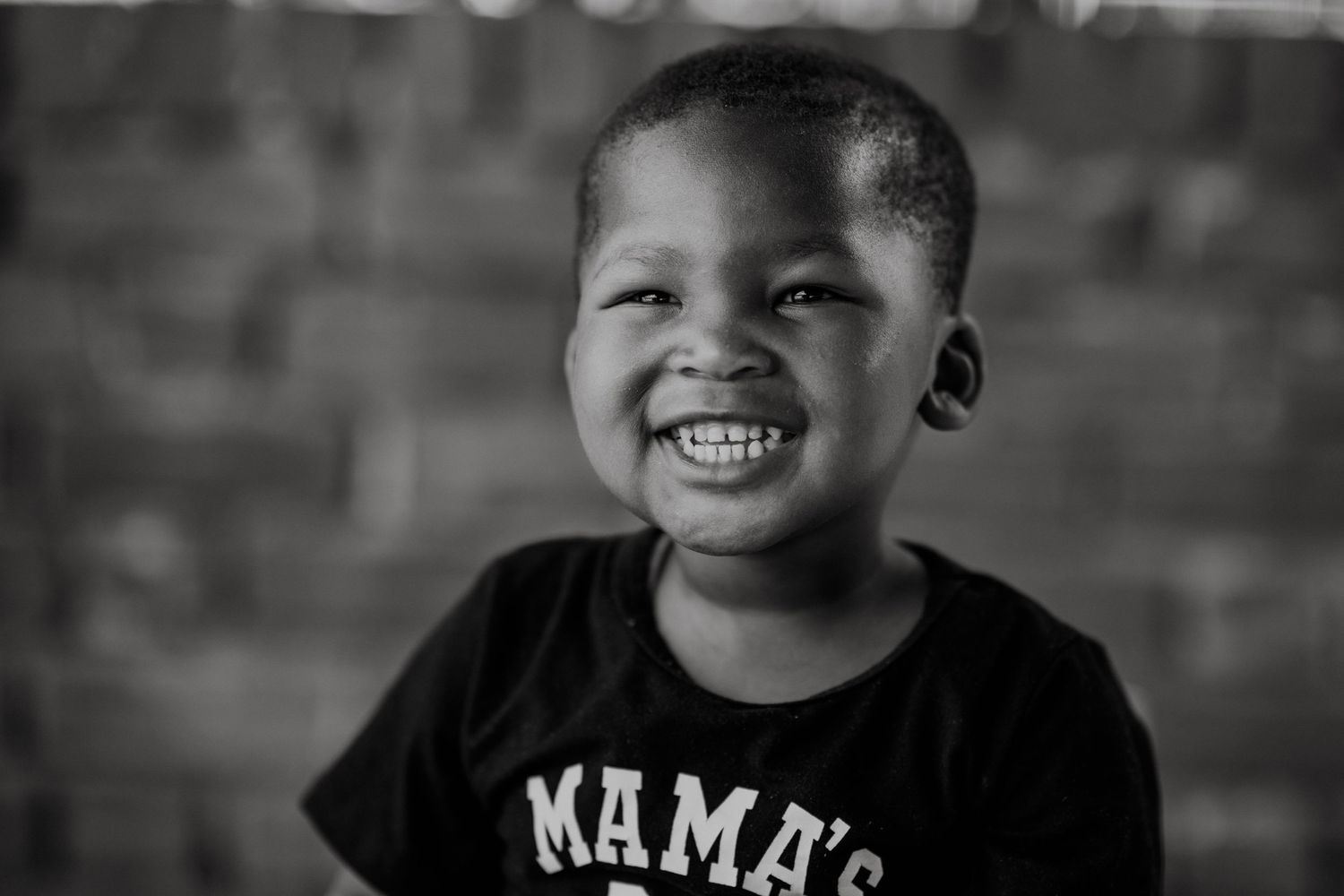 Candid portraits showing joyful expressions against dark background.