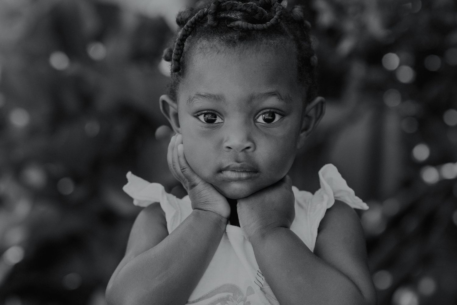 Black and white portrait series showing joyful expressions and white clothing details.