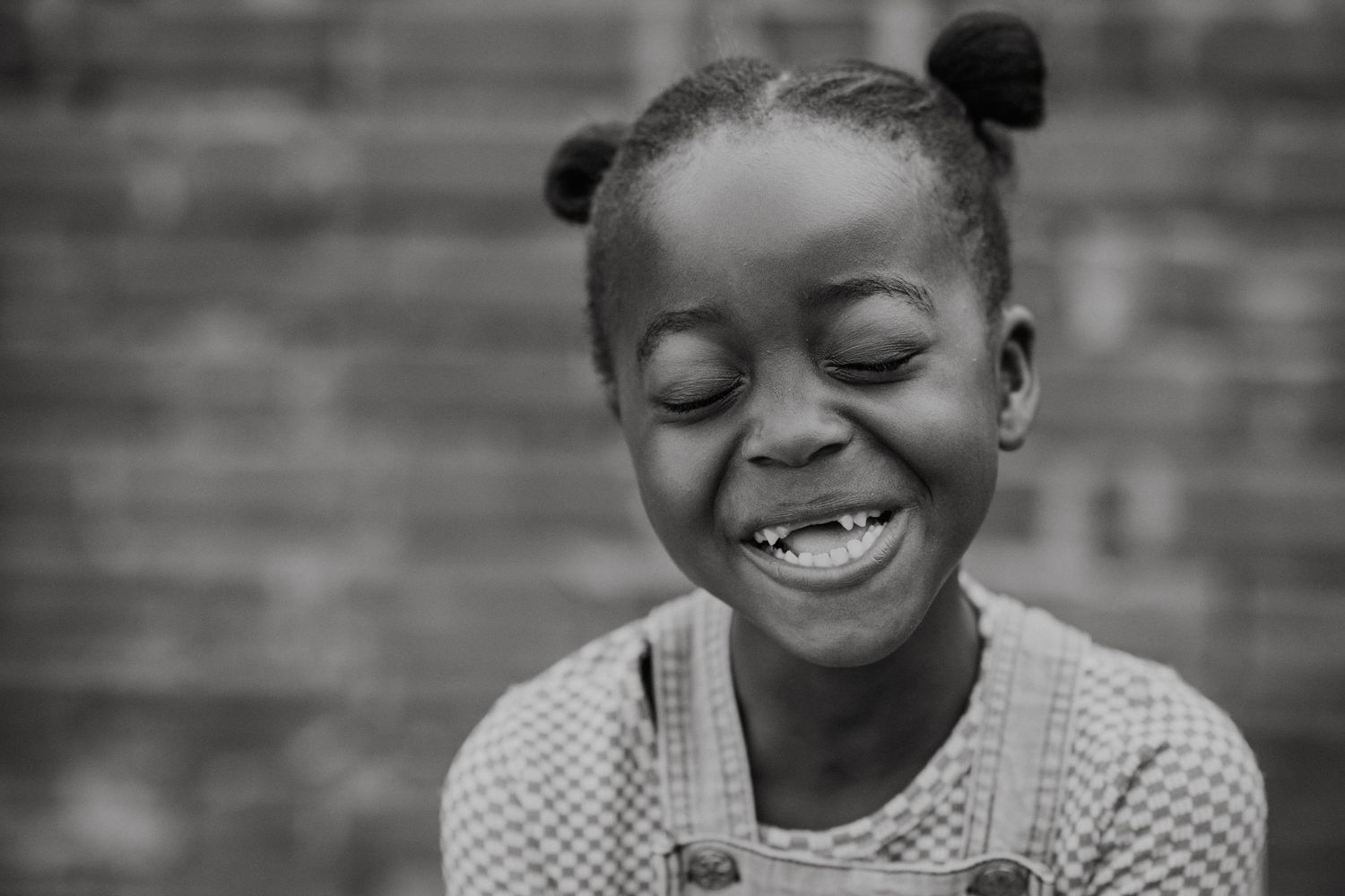 Black and white portraits capturing natural laughter and joy.