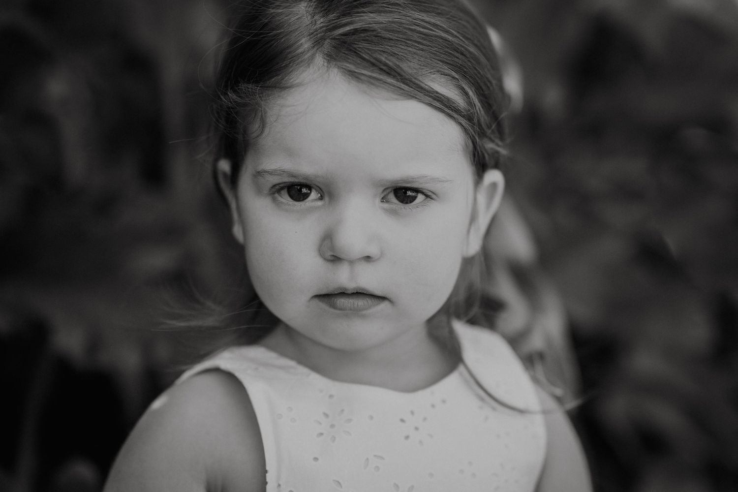 Black and white close-up portrait showing gentle expression and soft features.