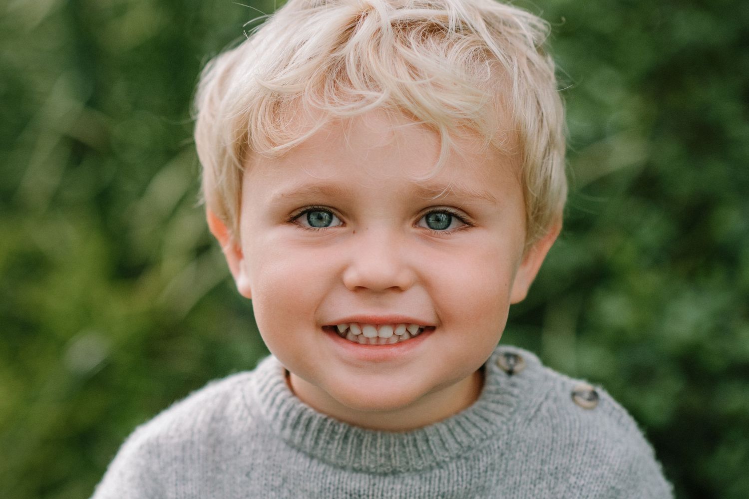 Outdoor portrait series showing gentle smiles in casual wear.