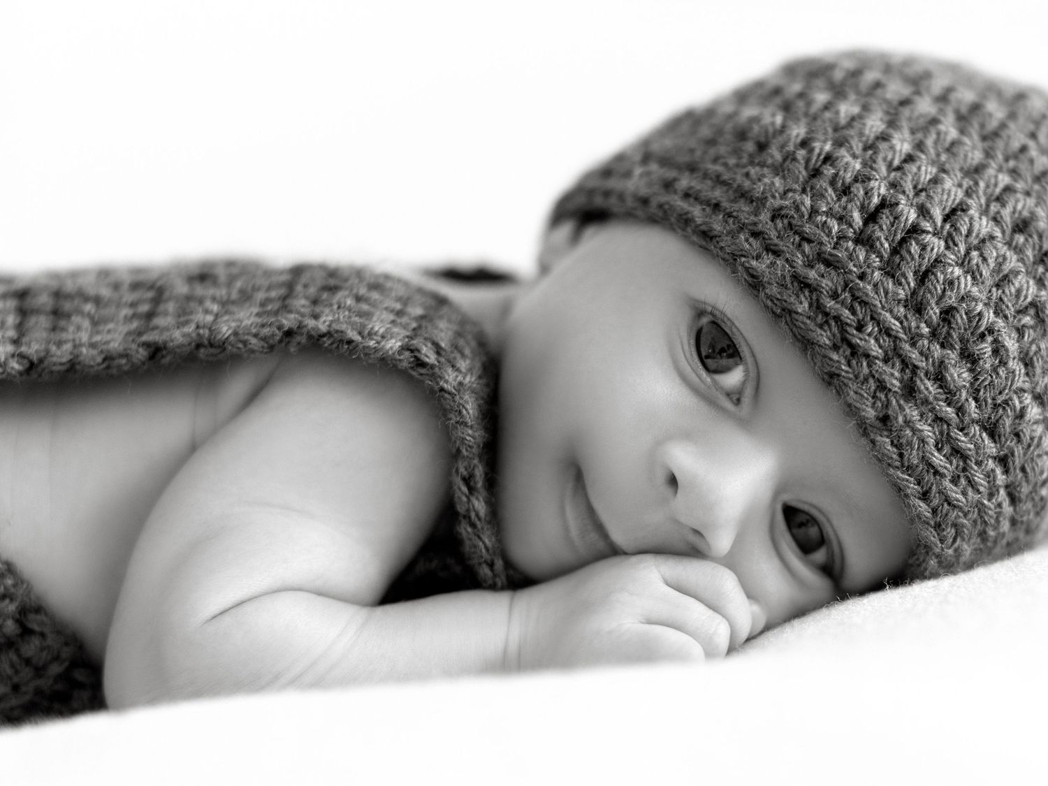 Newborn photography session capturing a calm sleeping baby