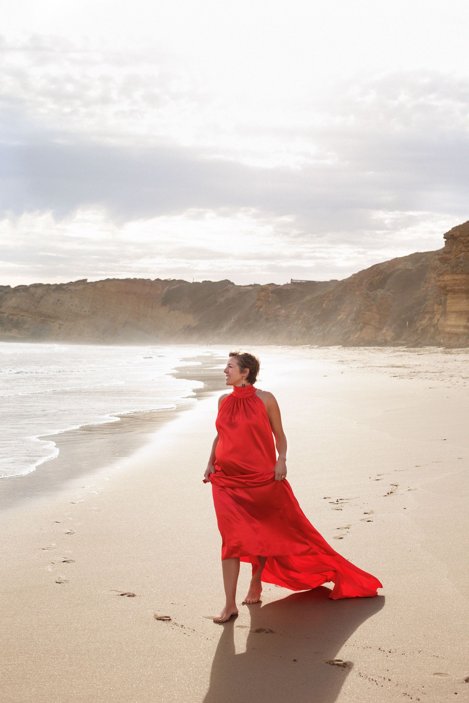 Maternity photography portrait with ocean waves in the background