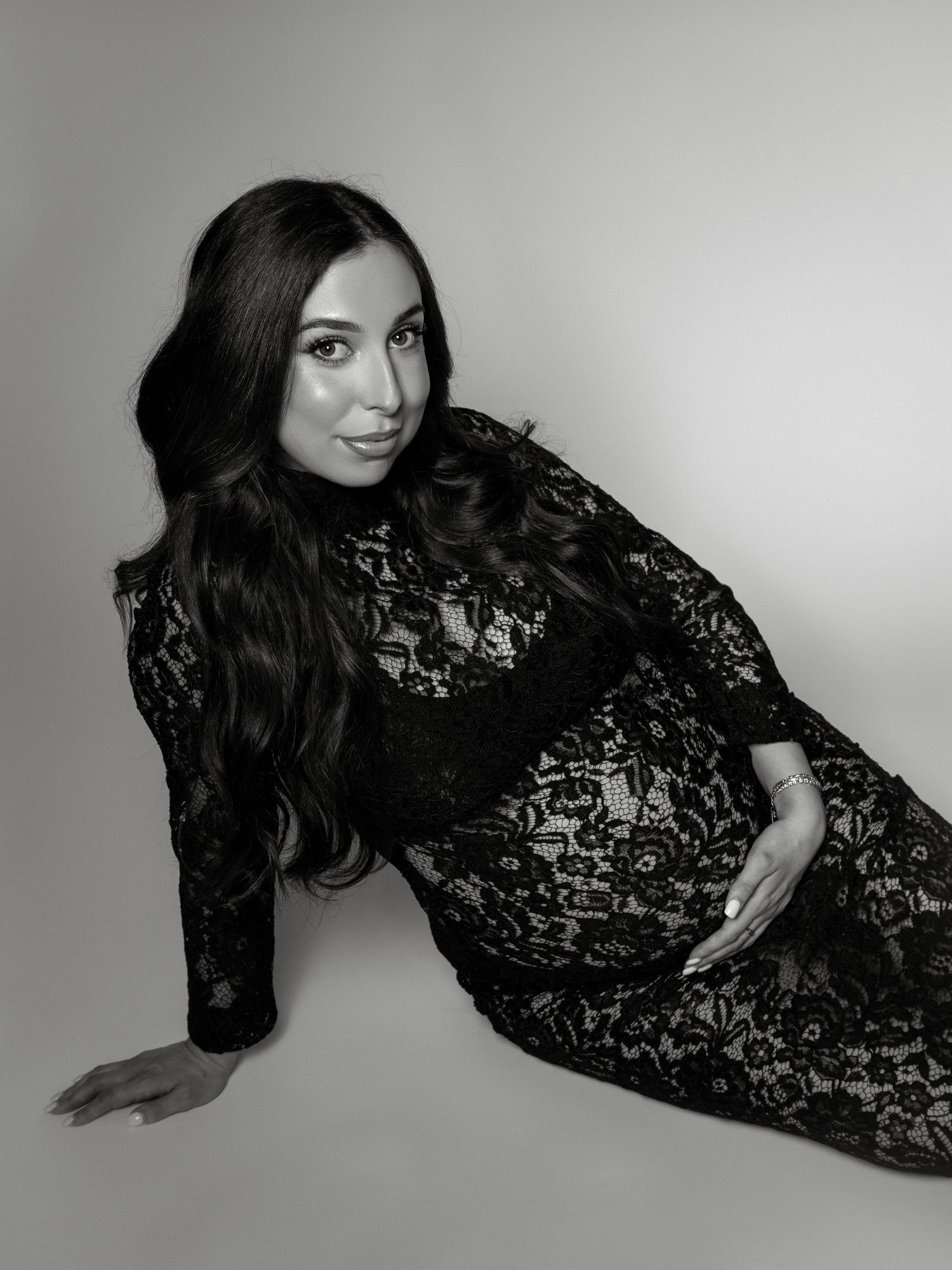 Studio maternity photography with professional lighting and neutral tones