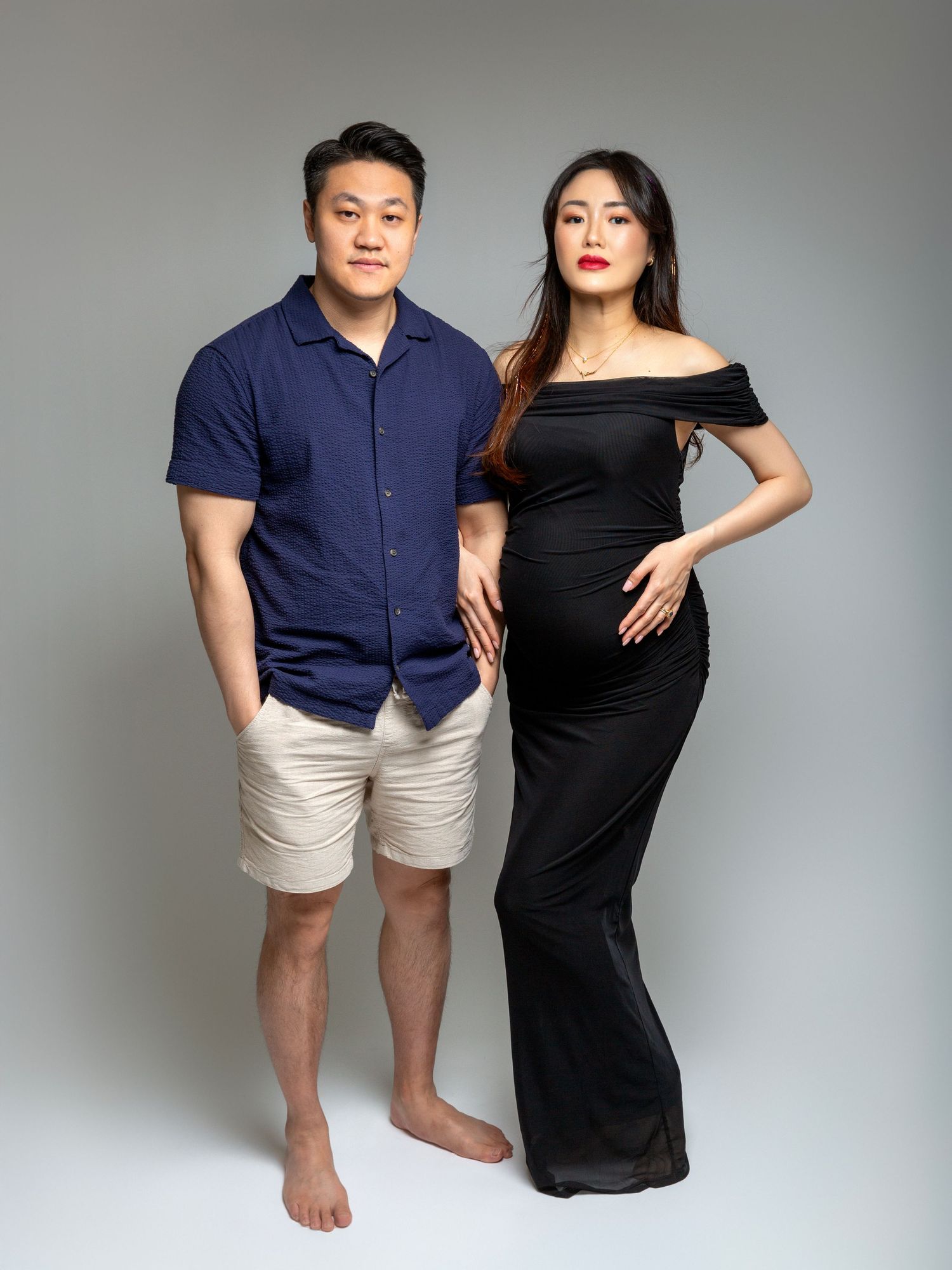 Maternity photoshoot in a professional studio with soft lighting setup