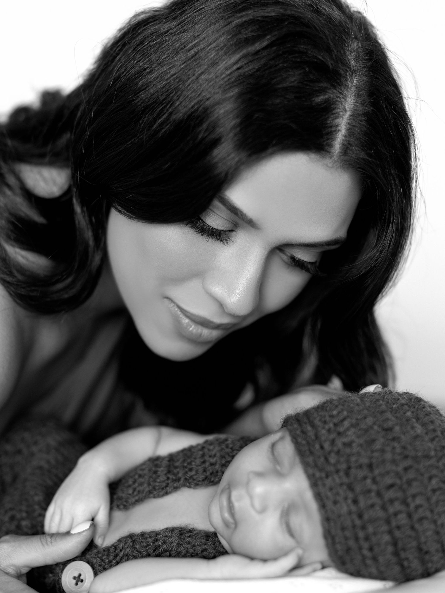 Newborn photography portrait showcasing baby’s tiny features